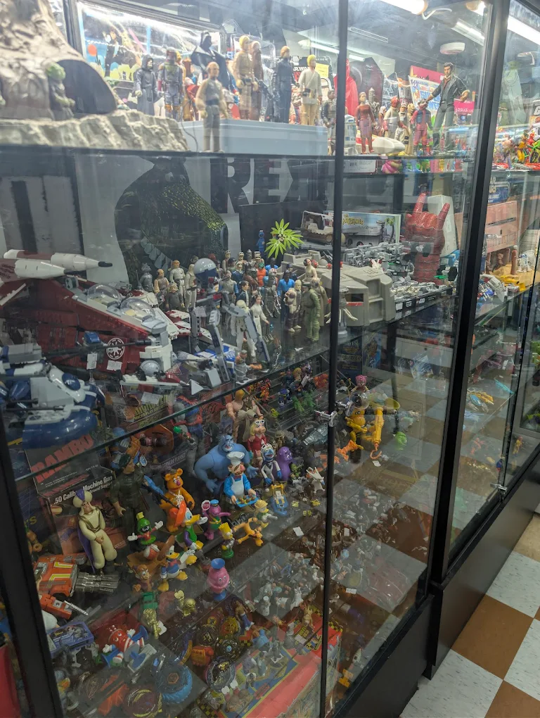 Glass case of vintage Star Wars figures and collectibles